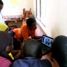 Deaf children chat to friends in Canada using Skype.