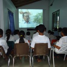 School children in Lveate Village watch filmed interviews with older villagers about their experience under the brutal Pol Pot regime. 