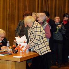 Senior citizens queue up to have their books signed by the famous author.
