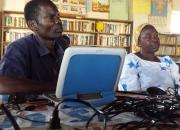 Two farmers learning computer skills in Caezaria Public Library in Uganda.