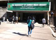 Students walk into the University of Zambia library. 
