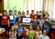 Children at Pelči Library (Latvia) celebrate the arrival of new equipment bought with the EIFL prize money - a touch screen computer monitor and a tablet e-book reader.