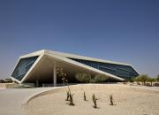 Qatar National Library building, photo from outside, showing driveway and triangular shape of building. 