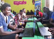Women and youth undergoing computer training in Zigoti Community Library, Uganda.