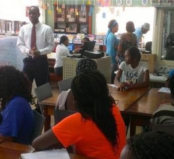 A businessman shares experiences of the world of work with young job-seekers in Micoud Public Library, St Lucia, Caribbean.