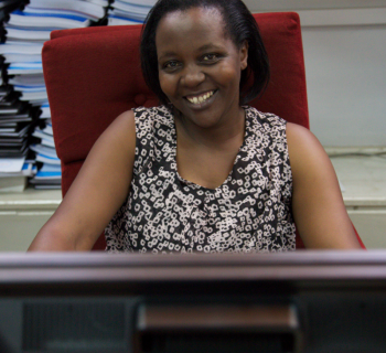 Grace Mugira, a librarian at the University of Nairobi library works at the computer uploading  to the Digital Repository Unit.