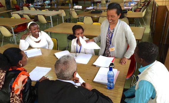 Five librarians at a table working together.