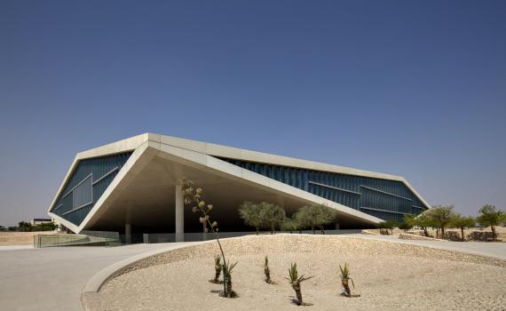 Qatar National Library building, photo from outside, showing driveway and triangular shape of building. 