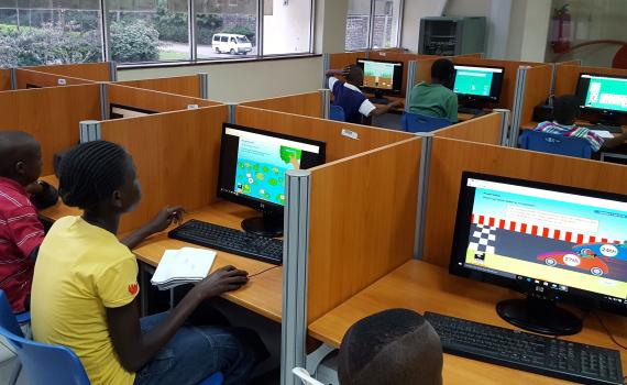 Children looking at computer screen with game