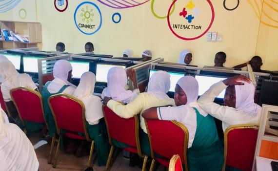 A group of schoolgirls in a classroom with computers.