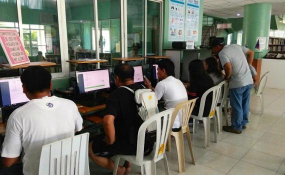 Overseas workers learn how to use computers and to apply online for their Overseas Employment Certificates in Butuan City Library. 