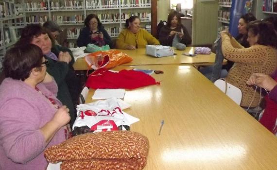 Women meeting in the library with their sewing and knitting. 