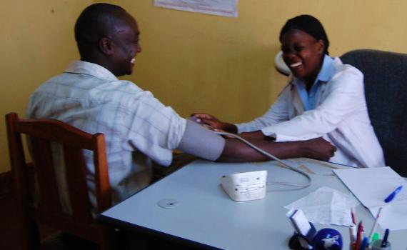 A health worker treating a patient at a clinic.