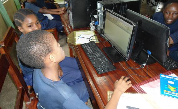 A young boy researches the internet in the Tanzania Central Library's computer room.