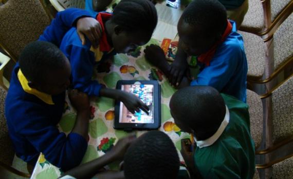Children use tablet computers in the library. 