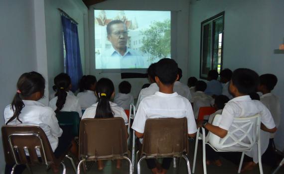 School children in Lveate Village watch filmed interviews with older villagers about their experience under the brutal Pol Pot regime. 