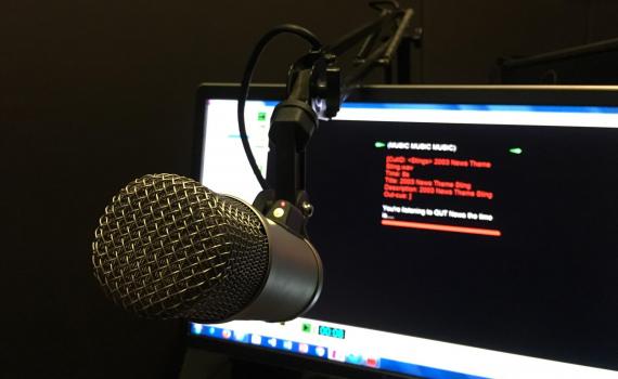 Image of a microphone with computer screen.