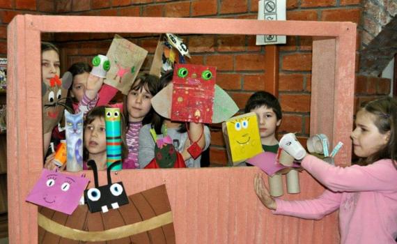 Children conducting a puppet show in Public Library ‘Radislav Nikčević’. They base the pubbet show on texts they have been reading.